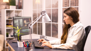 Creative female teacher editing the classroom recorded video using one of the best video editing software